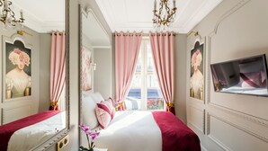 A hotel room with two beds, a large mirror, a TV, and a view of the city. - Merveil - Luxury Suite - Louvre - Ours I (Paris)