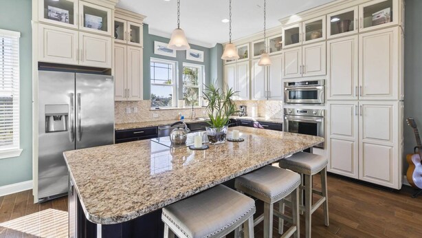 A spacious kitchen with granite countertops, stainless steel appliances, and a large island with bar stools. - Sunset Inlet Luxury Oasis | Ocean Views | Private Beach Access | Boat Slip | Beverly Beach | Dogs Ok (Flagler Beach)