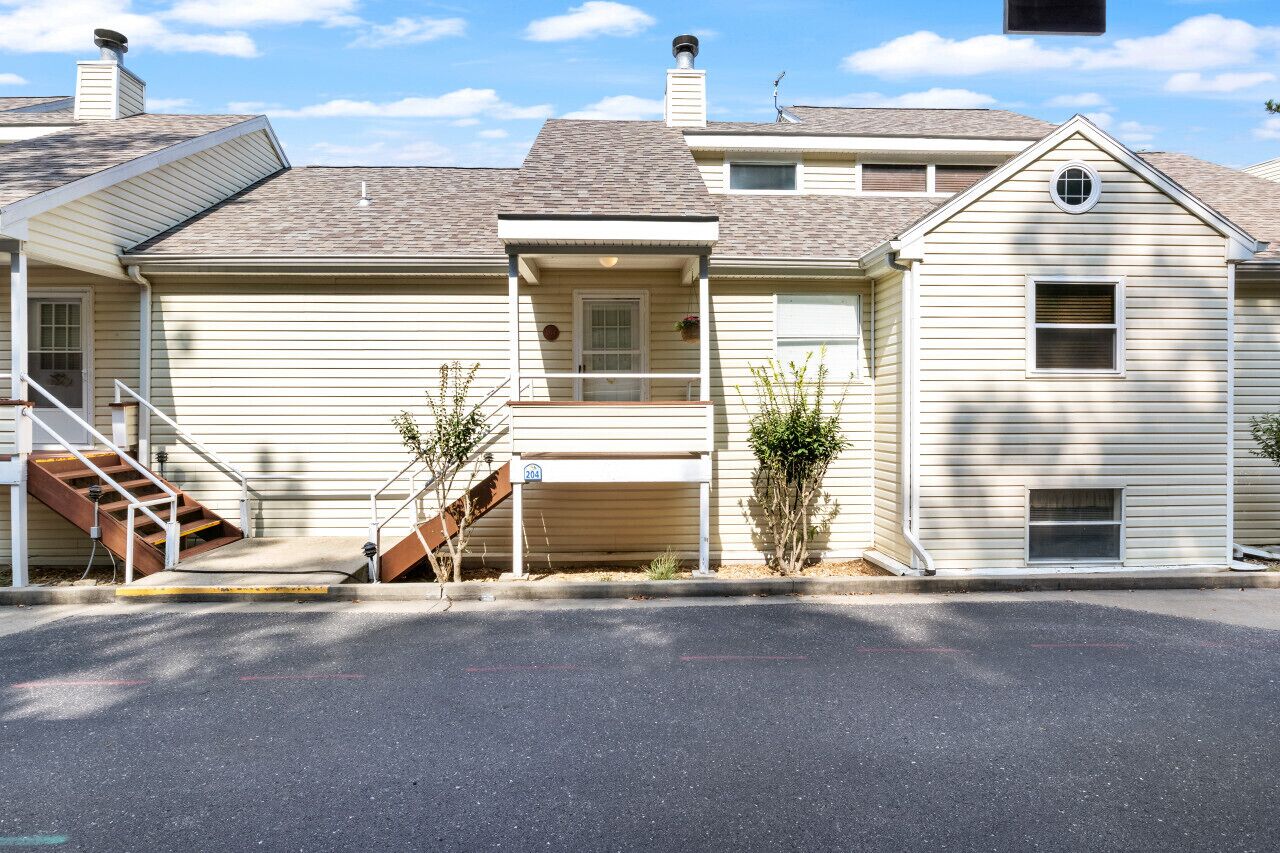 A two-story house with a front porch, a staircase, and a garage.