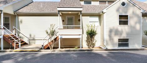 A two-story house with a front porch, a staircase, and a garage.