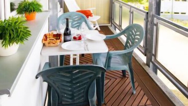 A balcony with a table, chairs, and potted plants. - Zur Düne I by Interhome (Zinnowitz)