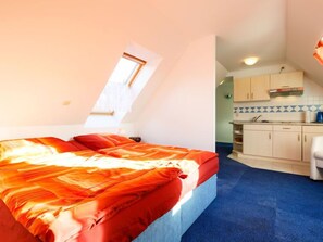 A compact room with a bed, a kitchenette, and a small bathroom. - Tauchmann II by Interhome (Koserow)