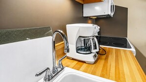 A kitchenette with a coffee maker, a sink, and a stove. - ML169 First Floor No Steps End Unit WiFi EZ Parking (Snowshoe)
