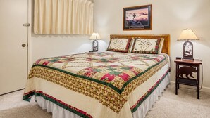 A bedroom with a large bed, two bedside lamps, a ceiling fan, and a framed picture on the wall. - ML169 First Floor No Steps End Unit WiFi EZ Parking (Snowshoe)