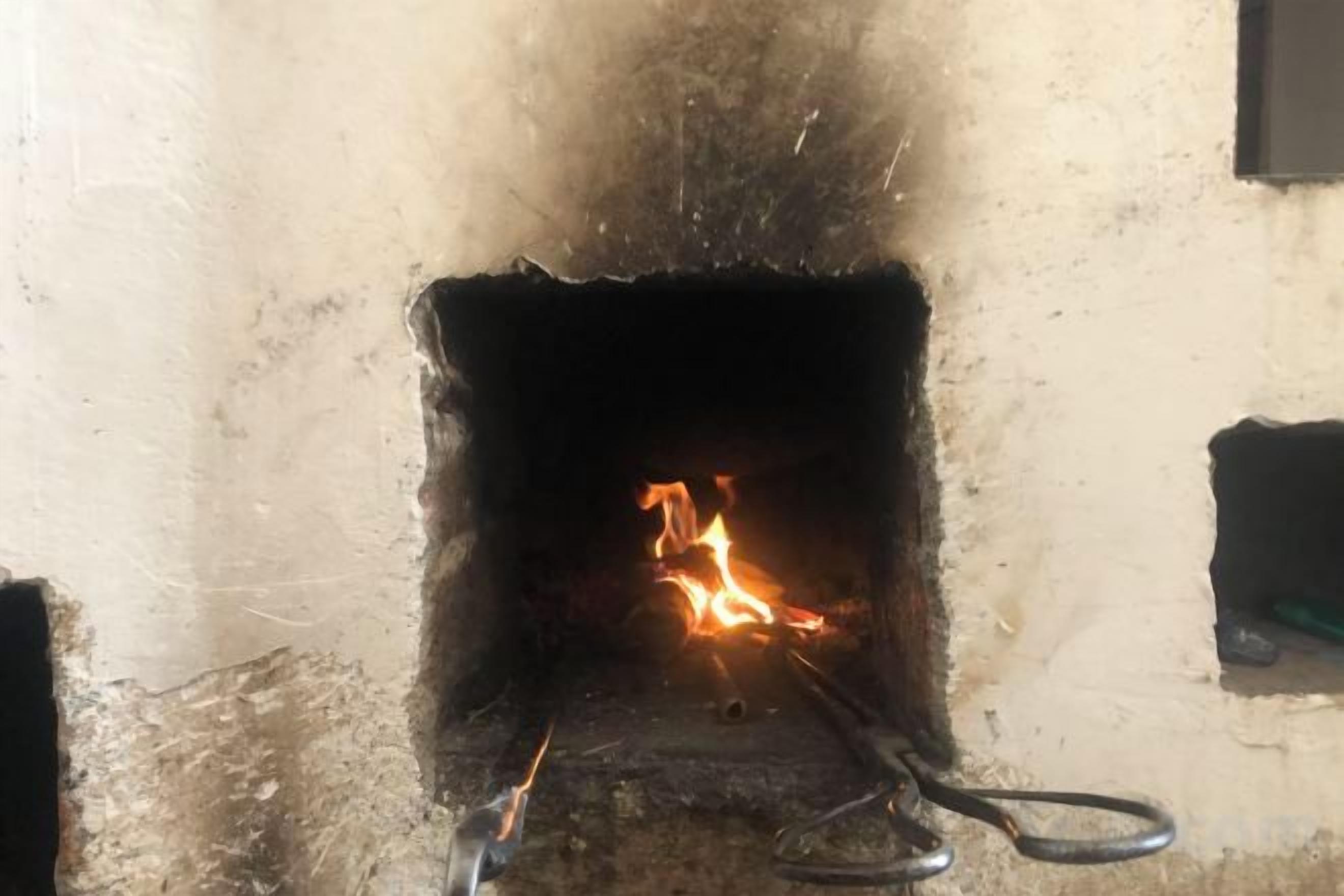 A fireplace with a visible fire.