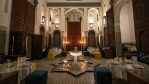 A luxurious dining area with ornate decor, a central fountain, and multiple seating arrangements. - Riad Fes Ziyat & Spa (Fes)