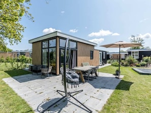 Outdoor dining - This attractive chalet is located in a beautiful location at the back of Schouwenduin, surrounded by (Burgh-Haamstede)