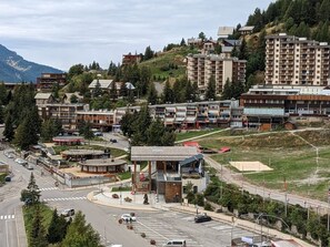 Urban hub with a central roundabout and multi-story buildings.