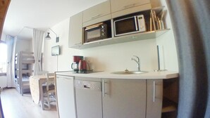 A compact kitchen with a microwave, coffee maker, and sink. - Renovated Studio for 4, balcony, ski-in/ski-out (Avoriaz)