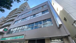 A multi-story building with a Lawson store on the ground floor.