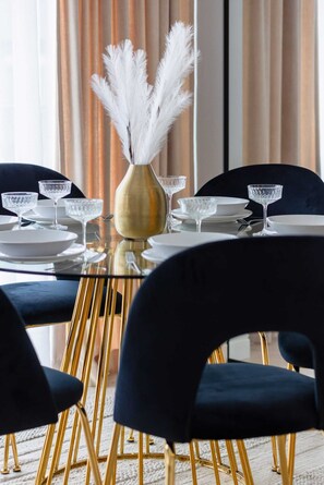 Enjoy meals in style at this beautifully set dining area with a round table and comfortable seating.