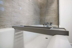Bathtub, hair dryer, shampoo