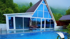 A modern building with a glass facade and a swimming pool. - 3Gozel Qabala (Gabala)