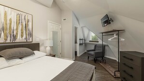 Een slaapkamer met een bed, een bureau, een stoel, een televisie en een kledingkast.