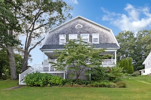 A two-story house with a front porch and a covered entryway.