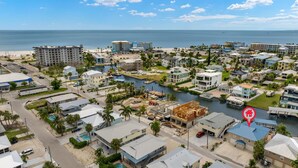 A coastal residential area with a marina, beachfront properties, and a variety of building styles. - Private Saltwater Pool- Canal Front- 5BR Kokomo (Fort Myers Beach)