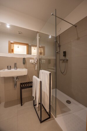 Shower, hair dryer, towels, toilet paper