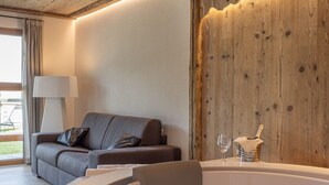 Ein modernes Badezimmer mit einer freistehenden Badewanne, einer Holzvertäfelung und einer Couch mit einer Lampe.