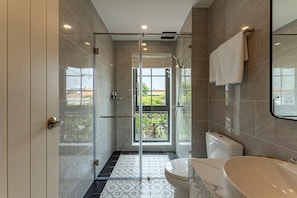 A modern bathroom with a glass-enclosed shower, a toilet, and a bathtub. - Golden Sun Apartment & Hotel (Ho Chi Minh City)