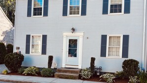 A two-story house with a front door, a small porch, and a mailbox. - Historic Newport...steps to downtown/wharfs dining, shopping, attractions (Newport)