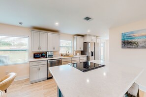 Enjoy cooking in this kitchen with a stovetop, ample counter space, and a refrigerator.