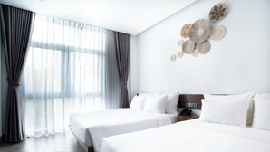 A hotel room with two beds, a large window with curtains, and a wall with decorative plates. - Velar Hotel (Ho Chi Minh City)