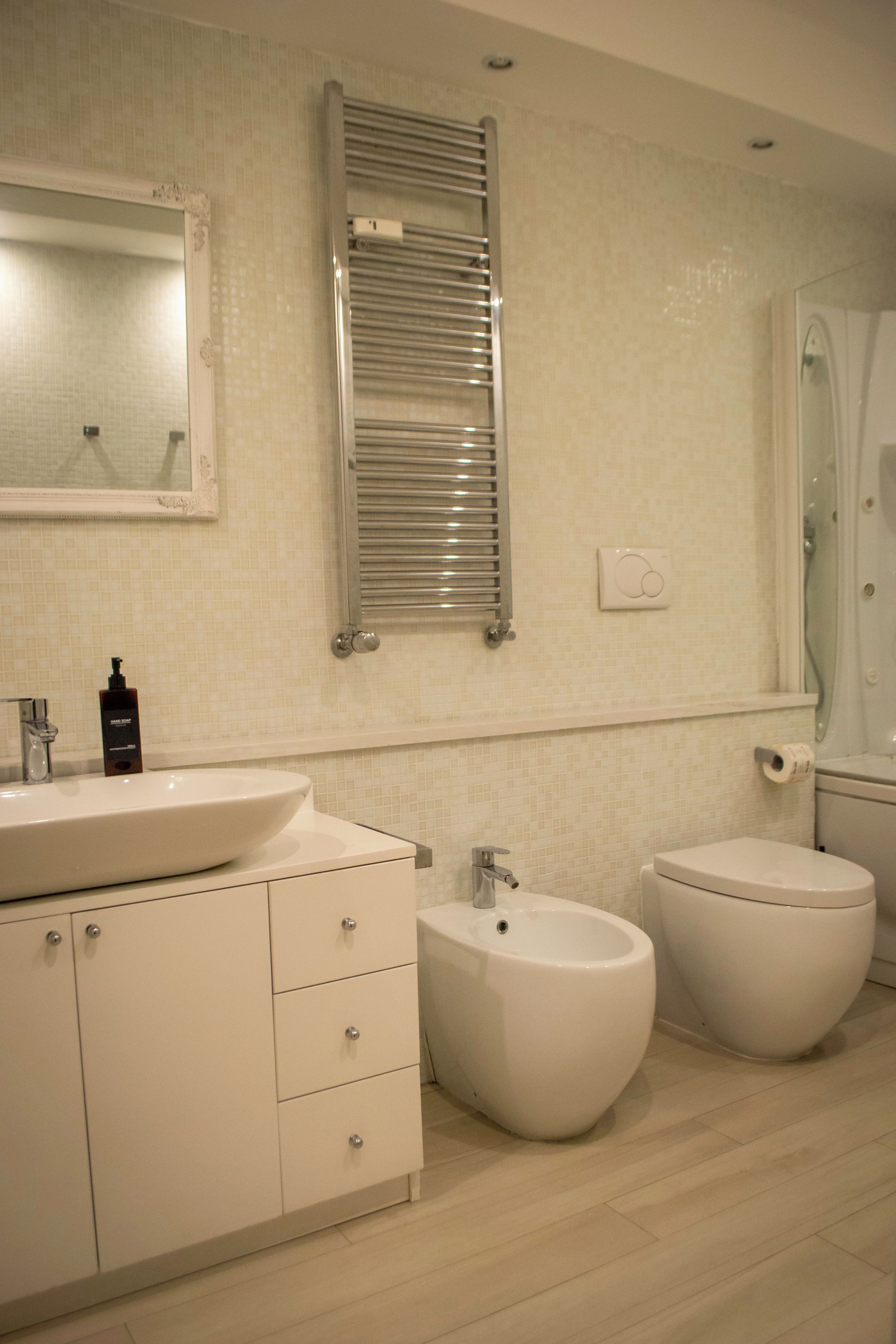 Une salle de bain avec un lavabo blanc, un bidet et des toilettes.