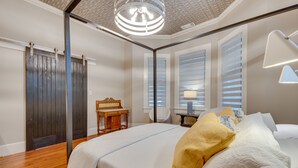 A bedroom with a bed, a desk, a chair, and a lamp. - Cozy + Modern Norcross Hideaway w/ Covered Porches (Norcross)