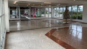Eine geräumige Lobby mit poliertem Boden, großen Fenstern und einem Weihnachtsbaum.
