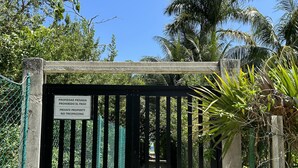 A gated entrance with a sign indicating private property and no trespassing.