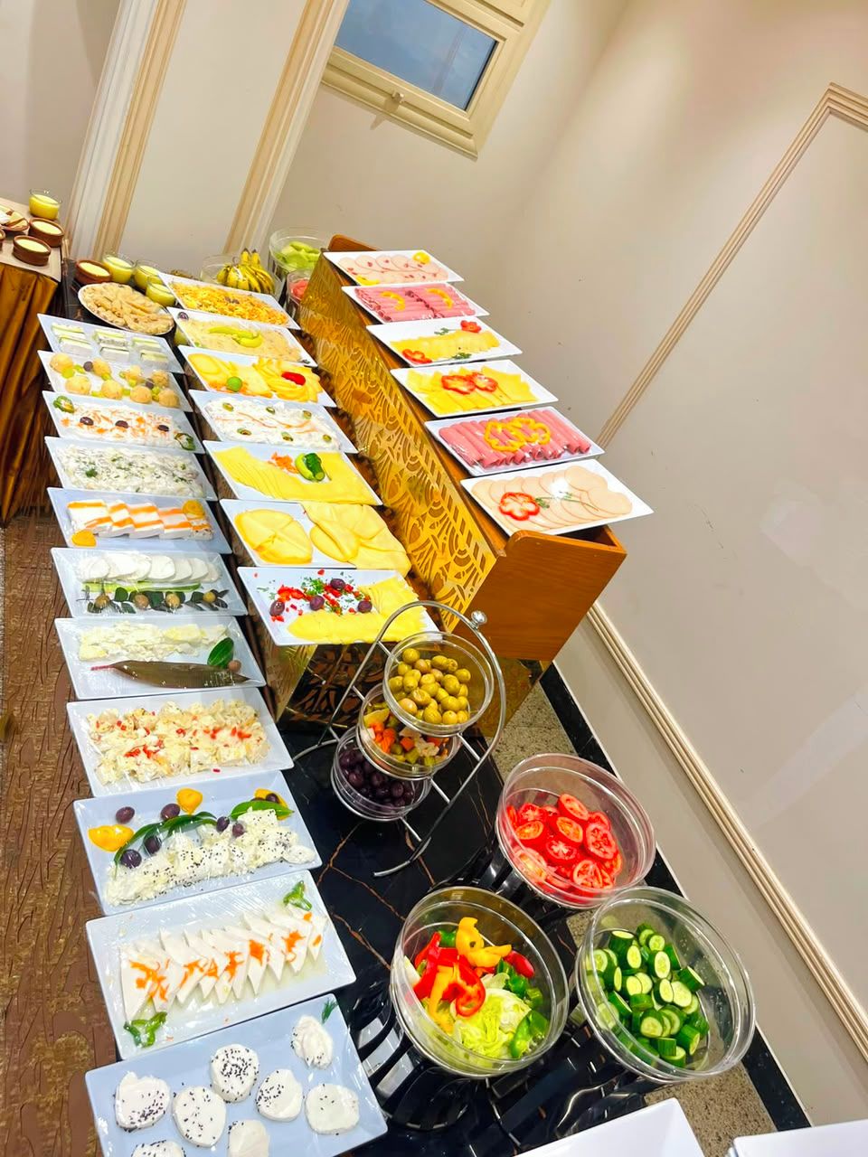 A buffet table with various food items and garnishes.