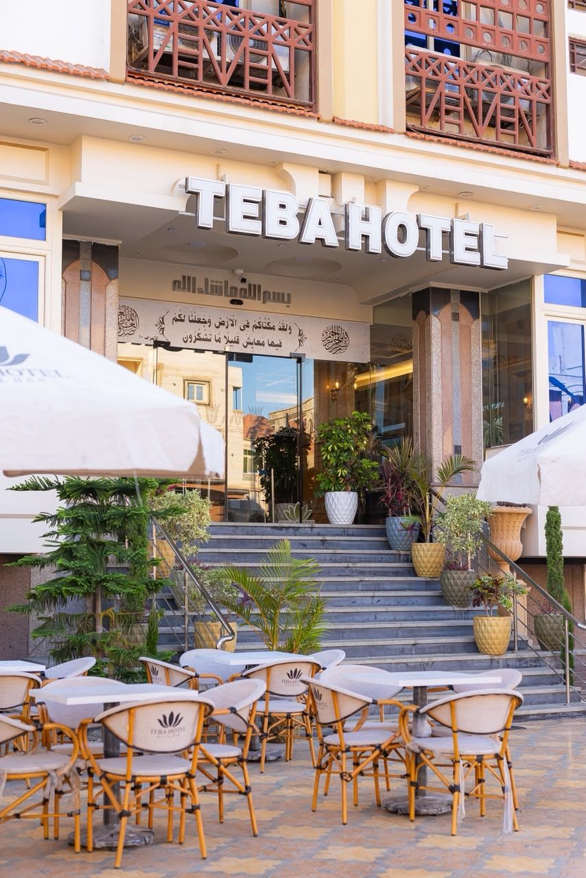 The entrance of the Tebahotel with outdoor seating and potted plants.
