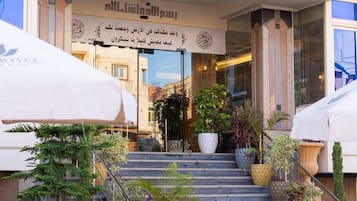The entrance of the Tebahotel with outdoor seating and potted plants.