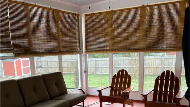 A sunroom with a ceiling fan, a sofa, two Adirondack chairs, and a patterned rug. - Charming Kentucky home! Walking distance to bars and restaurants. (Louisville)