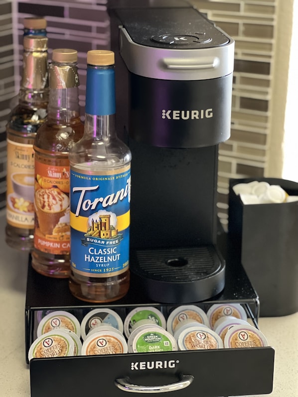 A coffee maker, Torani syrup, and coffee pods on a kitchen counter. - Spacious 3 Bedroom, Close Venice Beach (Marina del Rey)