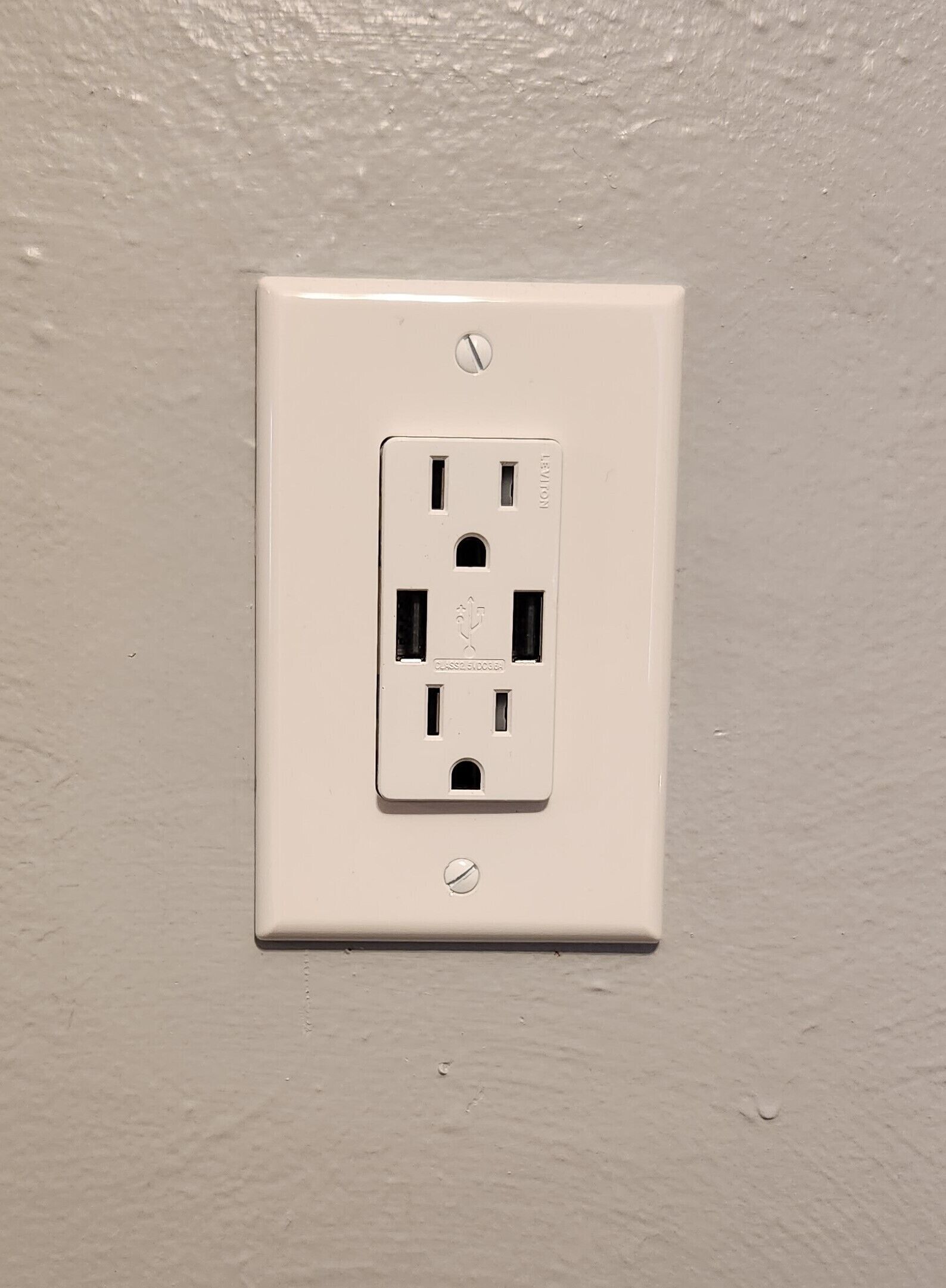 A white electrical outlet on a wall.