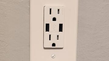A white electrical outlet on a wall.