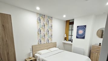 1 bedroom, desk, iron/ironing board, travel crib