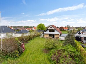 Stroll through a serene neighborhood surrounded by mature trees and a well-manicured lawn.