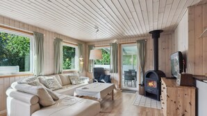 A cozy living room with a sofa, a coffee table, a fireplace, and a television. - "Viljo" - 30km from the sea by Interhome (Toftlund)