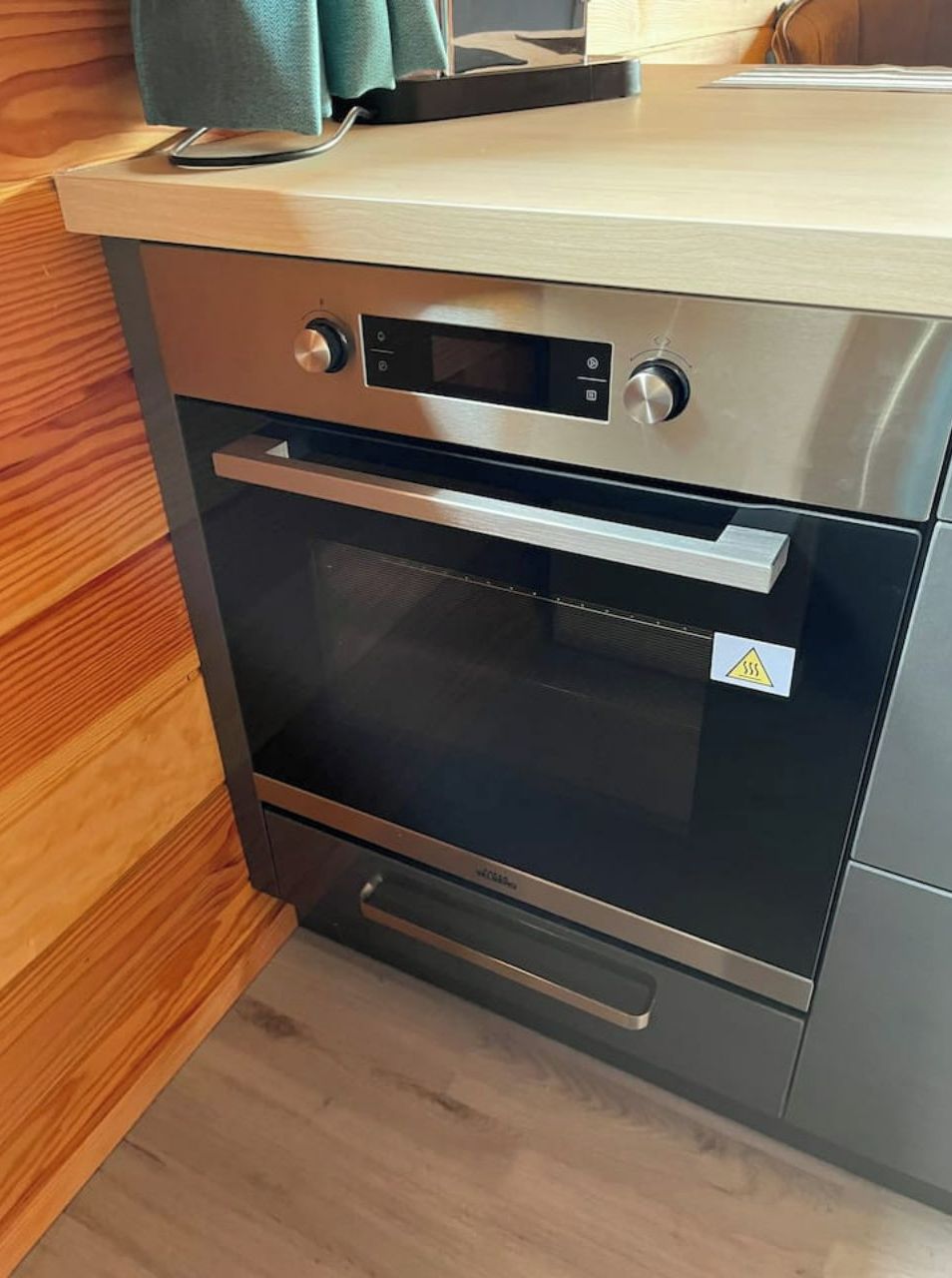Eine moderne Küche mit integriertem Backofen und Mikrowelle.