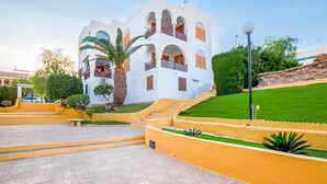 A white building with multiple balconies and a staircase leading to the entrance. - Awesome apartment in Puerto de Mazarron (Puerto de Mazarron)