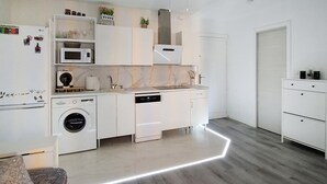 A modern kitchen with built-in appliances, a washing machine, and a dishwasher. - Awesome apartment in Puerto de Mazarron (Puerto de Mazarron)
