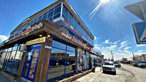 A two-story building with a restaurant on the ground floor named "Anadol pizza". - Zeraviktoria (Atyrau)