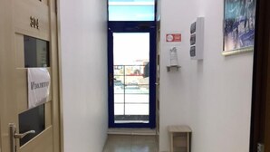 A hallway with a door labeled '304', a small table, and a painting on the wall. - Zeraviktoria (Atyrau)