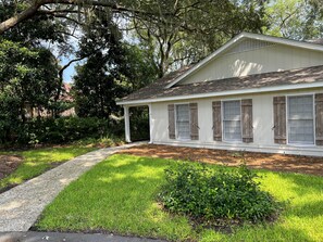 Stroll up to this charming single-story home surrounded by lush greenery and a well-manicured lawn.