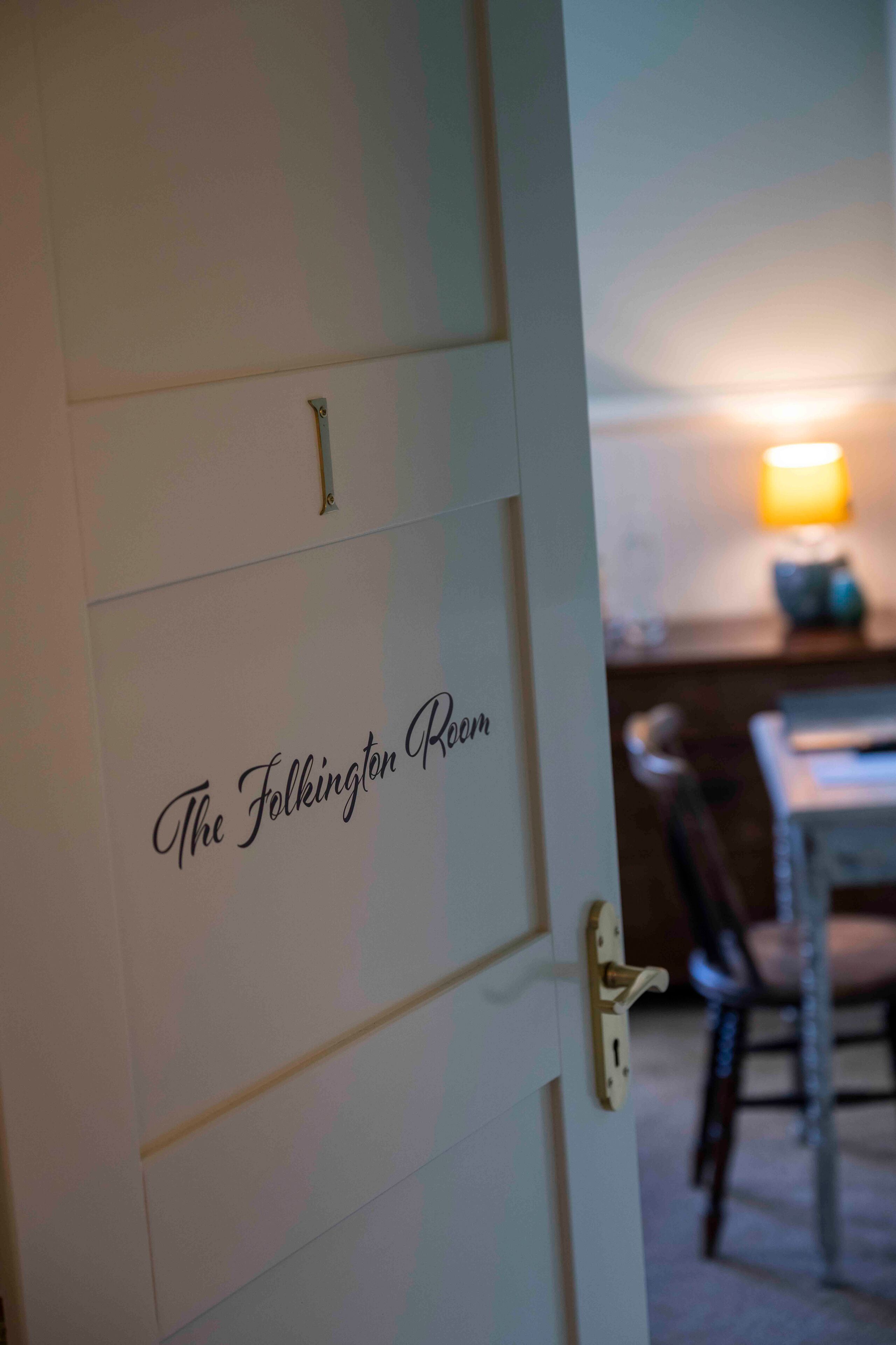 A door with a sign reading "The Folkington Room."