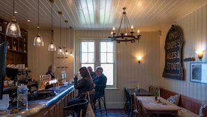 A bar area with wooden furnishings, a counter with taps, and a sign indicating the type of drinks served. - Long Man Inn (Polegate)