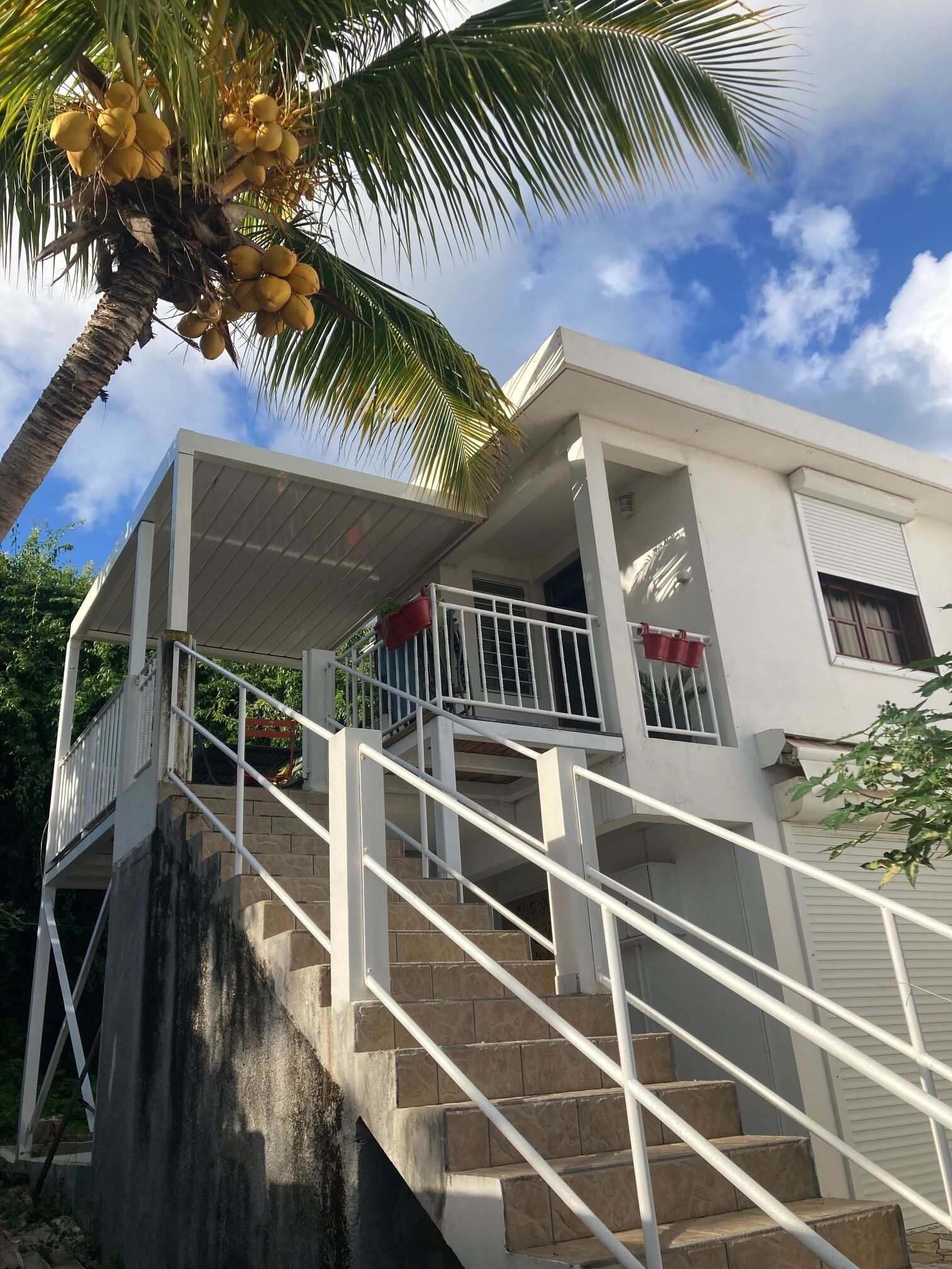 A two-story building with a staircase leading to a balcony.