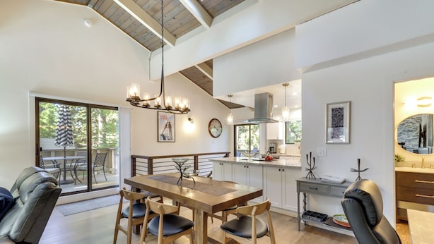 A modern kitchen with a wooden dining table, black chairs, and a large window. - Stylish Incline Village Vacation Rental w/ A/c! (Incline Village)